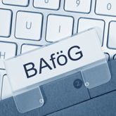 BAföG-Akte über Computer-Tastatur liegend